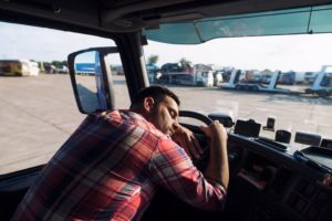 Tired truck driver sleeping in his cabin