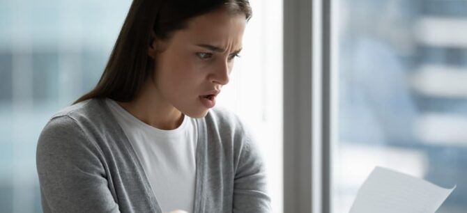 concerned woman looking at a document