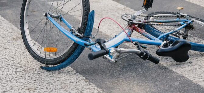 childrens bicycle lying on street