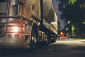 Truck driving on a road at night